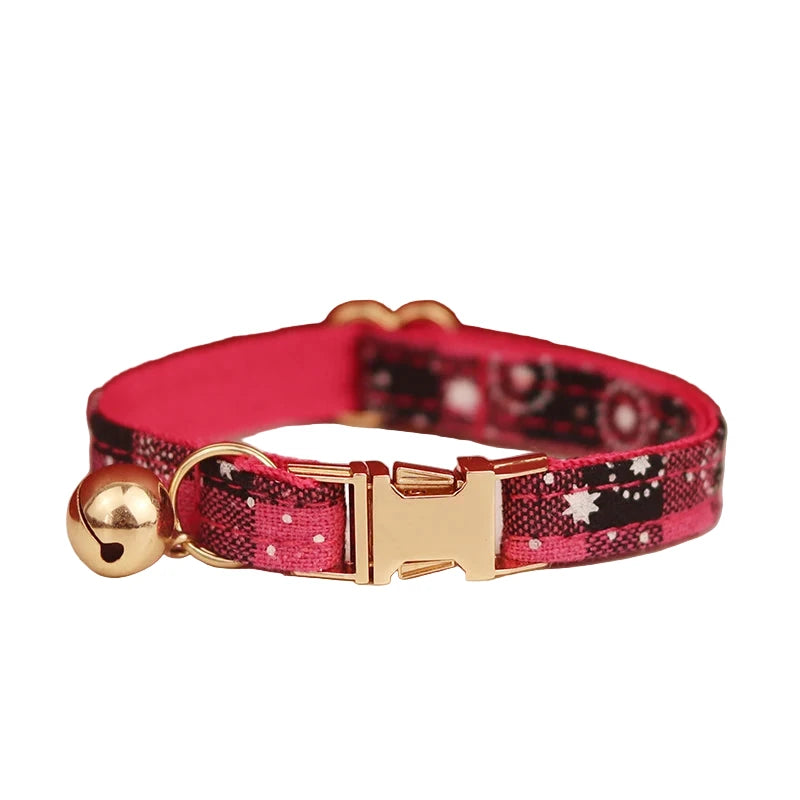 Pink and black patterned cat collar with gold buckle and bell