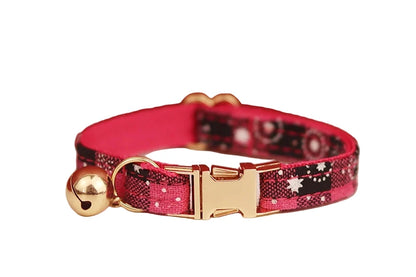 cat  collar with red and black pattern and gold buckle 
