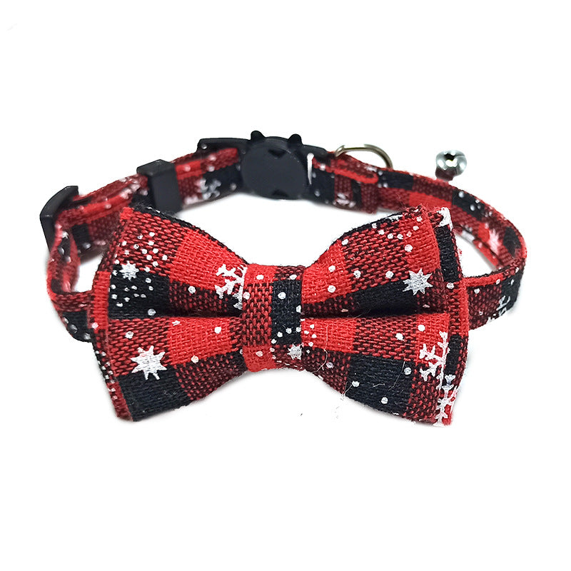 Red and black checkered bow tie with snowflake patterns on a white background
