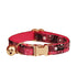 Pink and black patterned cat collar with gold buckle and bell 